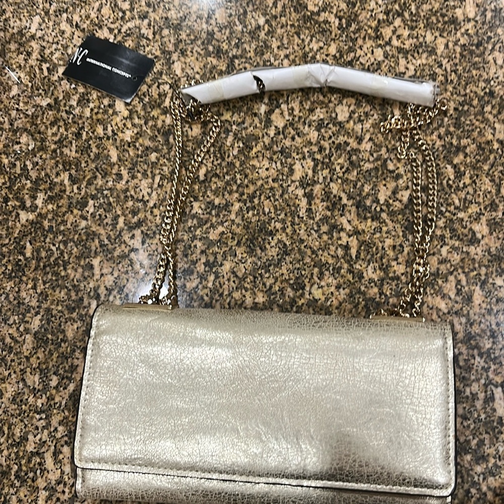 This is a new INC. shoulder purse. Multiple pockets inside.
